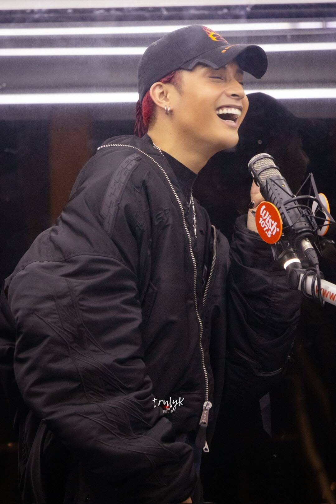 red haired Felip in a cap laughing